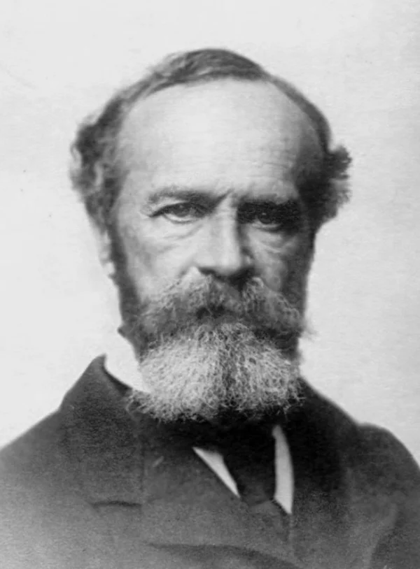 Black-and-white portrait of William James, a bearded 19th-century American philosopher and psychologist, looking at the camera with a serious expression