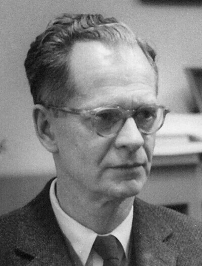 Black-and-white photograph of B.F. Skinner at Harvard around 1950, an older man with glasses looking down to the right